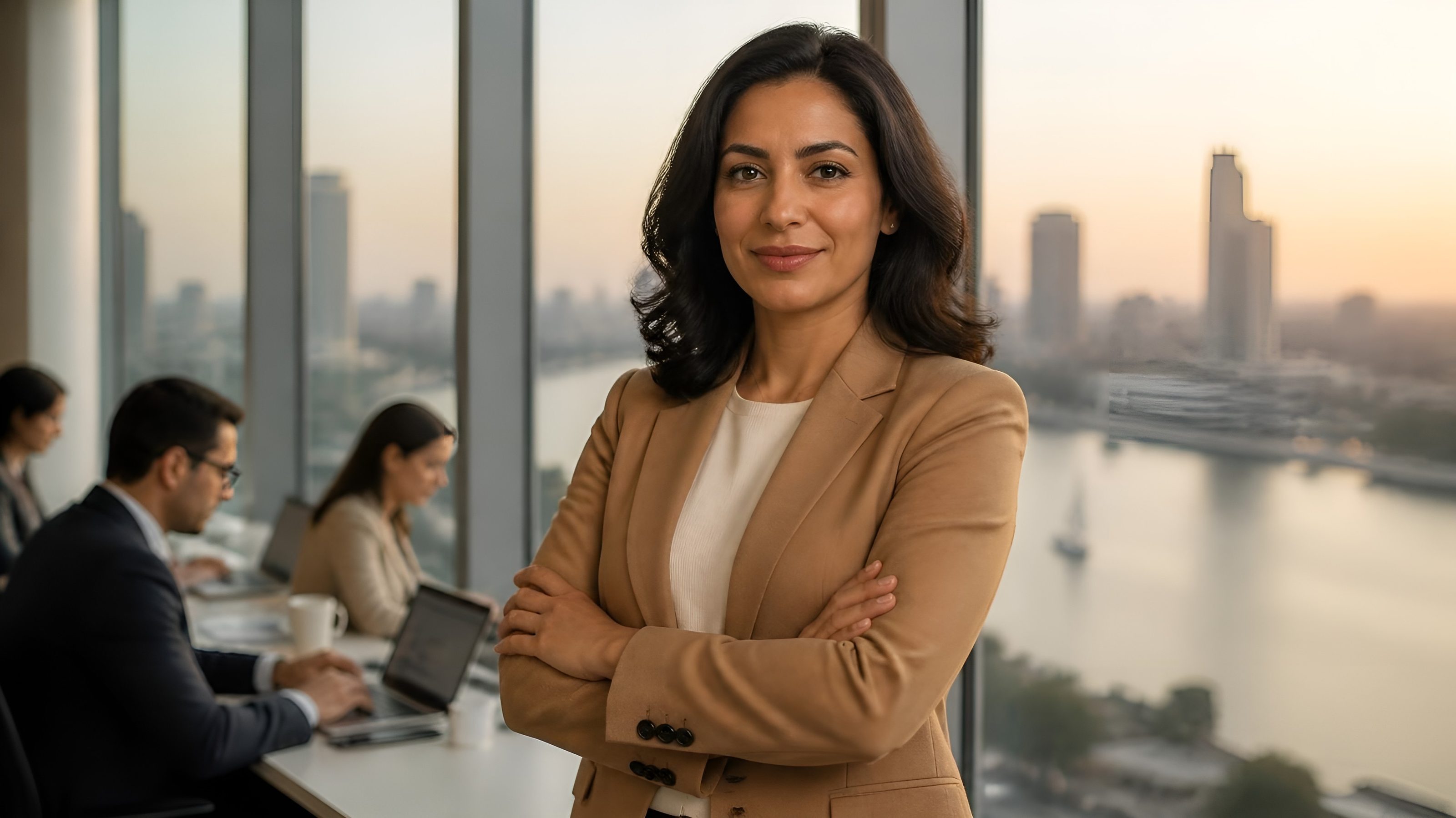 Egyptian founder standing in her Cairo office with the Nile behind her